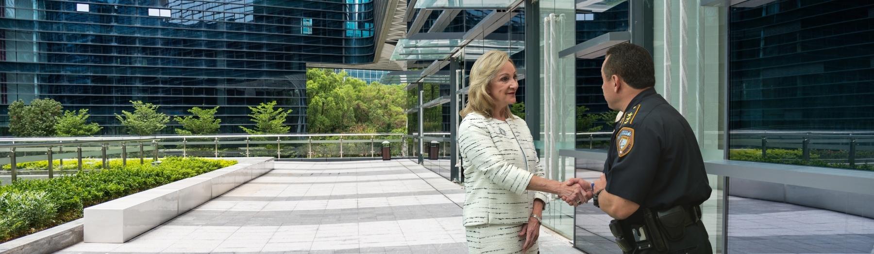 image of District Clerk Marilyn Burgess, who works closely with local law enforcement agencies. In this photo, she is greeting Edison Toquica, Chief Deputy at the Harris County Sheriff’s Office